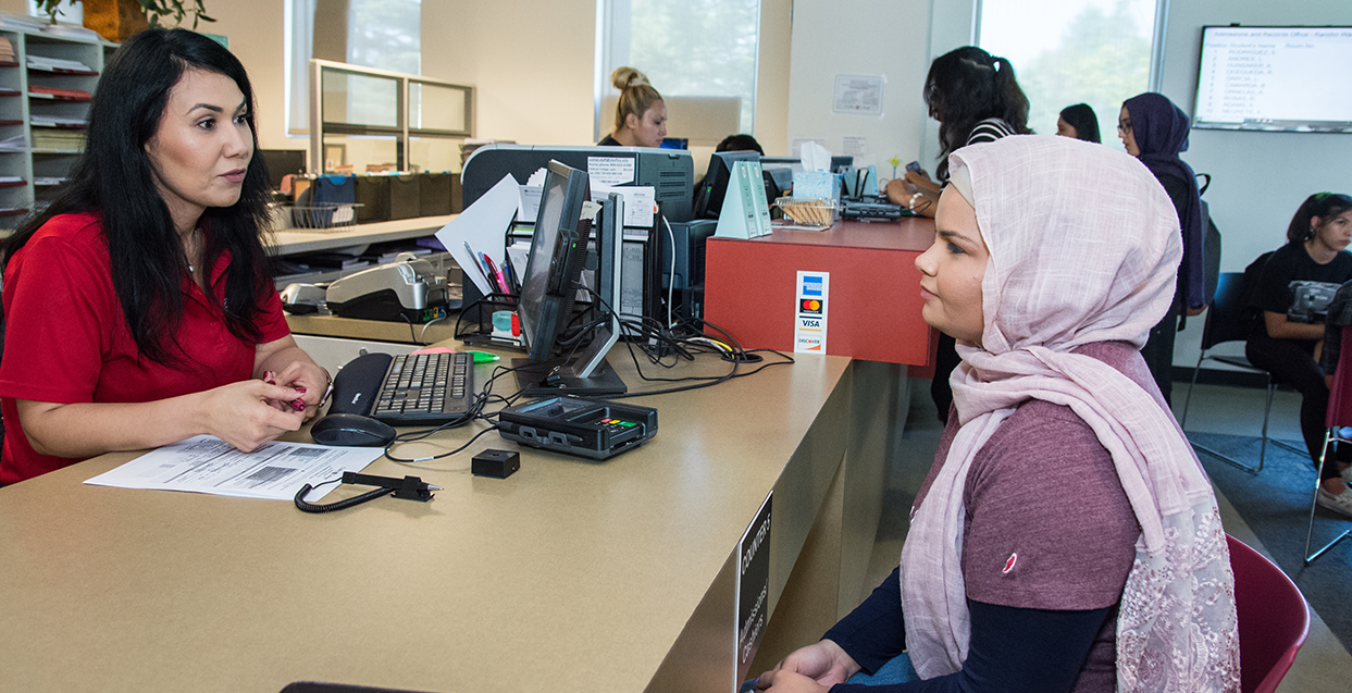 A student receives guidance from a financial aid advisor.